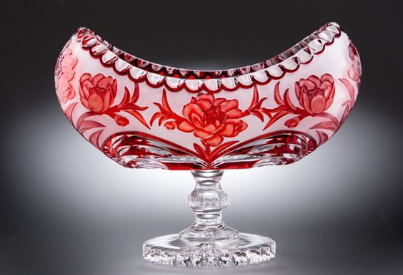Red decorative glass bowl on pedestal with floral engravings